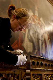 One of the conservators installing the Charles II bedrail