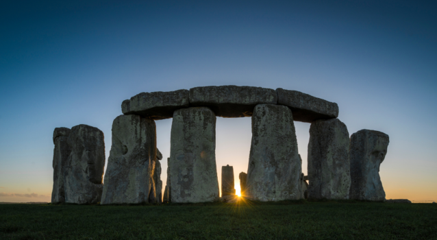 A photo of Stonehenge in front of a sunset