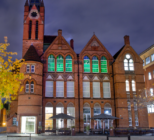 The Ikon Gallery in Birmingham, with top floor windows lit up in green light
