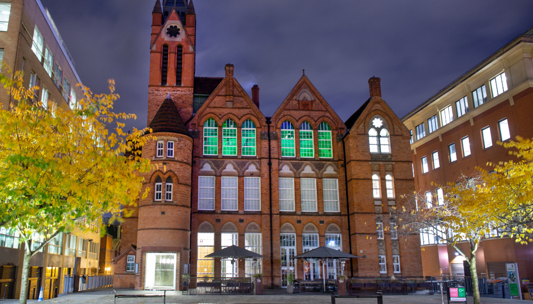 The Ikon Gallery in Birmingham, with top floor windows lit up in green light