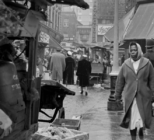 People walking past market stalls in Rupert Street, Soho. 1955-1965