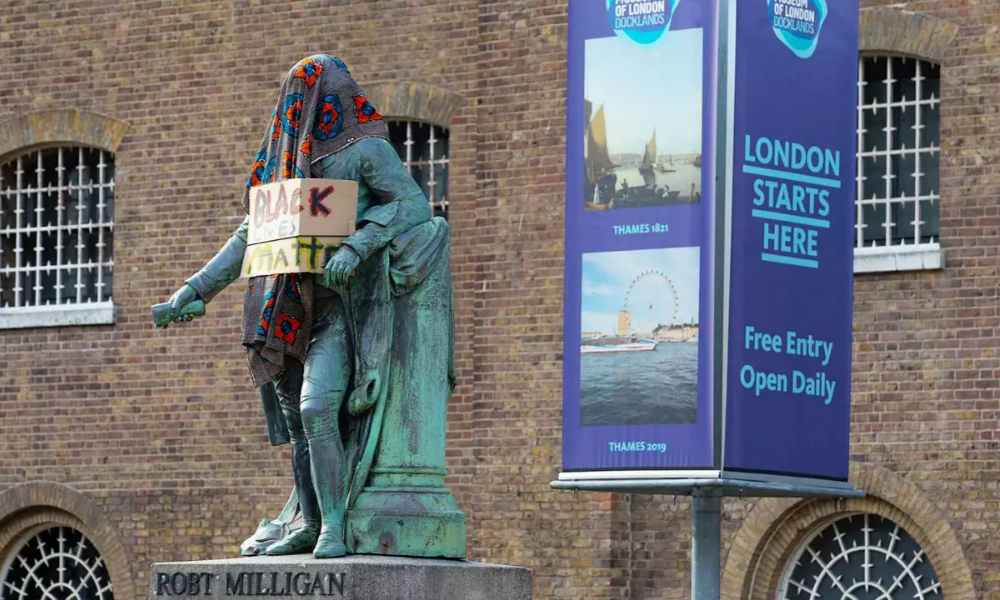Robert Milligan statue with protest placard and cloth before removal in June 2020 © David Parry Museum of London