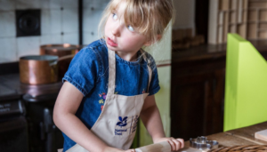 A child making craft in the kitchen at The Children's Country House at Sudbury (National Trust Images, Annapurna Mellor)