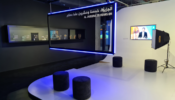 A photograph of the exhibition shows an area designed to resemble a television studio