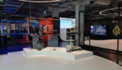 A photograph of the exhibition shows two TV studio cameras