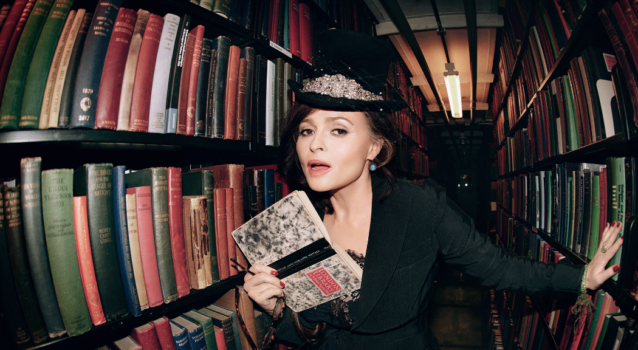 A photograph of Helena Bonham Carter CBE, holding a book inside The London Library