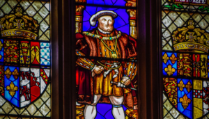 A stained glass of Henry VIII, one of the subjects of the film at Hampton Court.