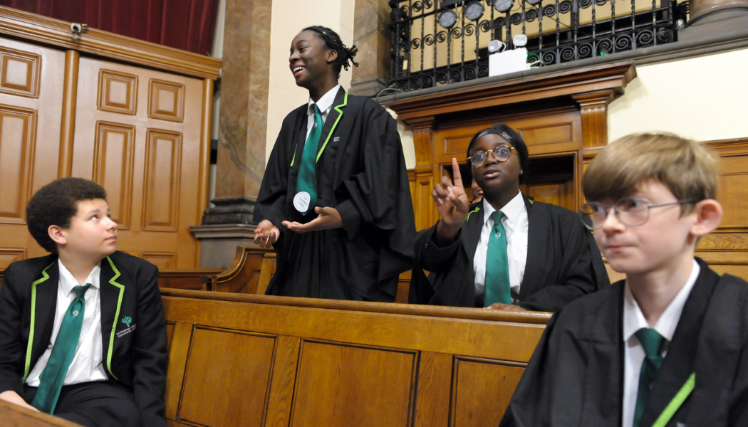 Young people debate climate change in the courtroom of the National Justice Museum in Nottingham on Takeover Day 2021 (George Archer for Kids in Museums)