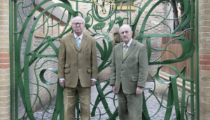 Gilbert & George at the gates to The Gilbert & George Centre Photograph- Yu Yigang © Gilbert & George