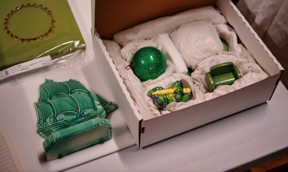 A selection of green objects - ranging from a 17th Century Spanish Necklace to Teenage Mutant Ninja Turtle, Donatello, 1989. Being packed ready to move into Young V&A’s Play Gallery. © Jamie Stoker